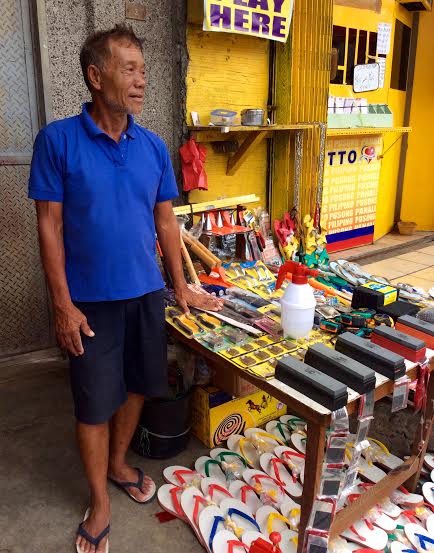 Mano Pinok in his sidewalk vending stall - where he was proudly showing us more wares to sell. All because of HHFT help, he said.